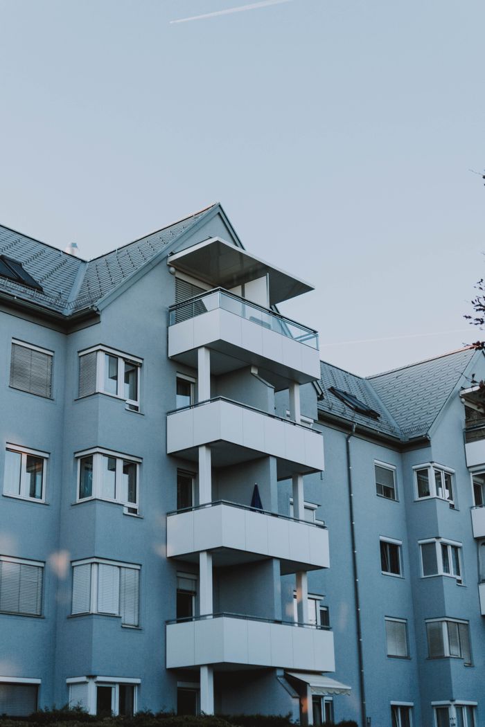 Contemporary architecture of an apartment building with balconies against a clear sky.